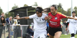 Nilab (left) of the Afghan women’s team keeps possession in their first Australian match on Sunday.