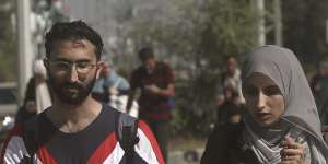 Palestinians flee Gaza City to the southern Gaza Strip on Salah al-Din street in Bureij on Tuesday.