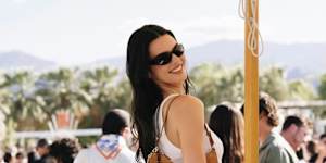 Kendall Jenner in the unofficial Coachella uniform carrying a Kate Spade New York handbag.