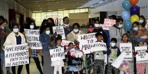 Supporters welcome the Murugappans at Perth Airport.