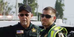 Police officers direct traffic near Trump International Golf Club after the apparent assassination attempt.