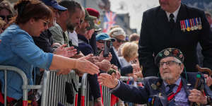 D-Day veterans are applauded by the crowd after a parade with a Royal Guard Of Honour in Arromanches-les-Bains,France.