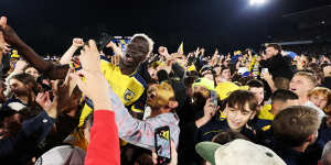 Alou Kuol of the Central Coast Mariners celebrates winning with fans.