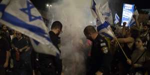 Protesters and Israeli police officers clash during a demonstration.