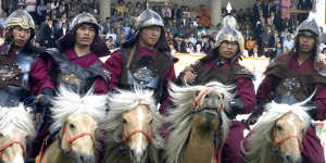 Riders in traditional dress perform at the opening ceremony of Naadam.