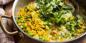 Ready in a flash:Quick curried rice with egg,spring onions and peas.