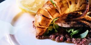 Grilled calamari on olive tapenade with rocket at Grill Americano. 