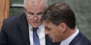 Prime Minister Scott Morrison listens as Minister for Energy Angus Taylor speaks during question time on Thursday.