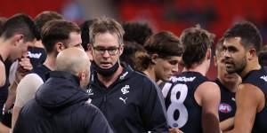 Carlton coach David Teague walks away after talking to his players during the loss to Greater Western Sydney.