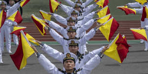 Chinese sailors perform signals with flags at the PLA Navy’s Submarine Academy to mark the navy’s 75th anniversary in Qingdao,China,on April 21.