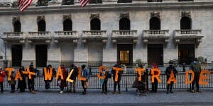 “Tax Wall Street trades”:a group of demonstrators outside the New York Stock Exchange building protest against restrictions on trading GameStop amid stock chaos in New York City on January 28. 