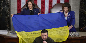 US Vice President Kamala Harris and then-House Speaker Nancy Pelosi,right,after being presented with a Ukrainian flag by President Volodymyr Zelensky. The flag was signed by front-line troops in Bakhmut.