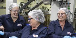 Jessica Anderson,Julie Higgins and Karen Revell churn out ice-cream at Norco’s rebuilt factory in Lismore on Thursday.