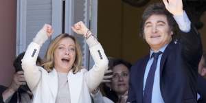 Italian Prime Minister Giorgia Meloni (left) and Argentine President Javier Milei wave to supporters from a government house balcony,in Buenos Aires in November.