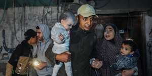 Palestinians are evacuated from a building hit by Israeli air strikes in Rafah,Gaza.