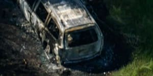 The burnt-out shell of what appeared to be a Kia Carnival.