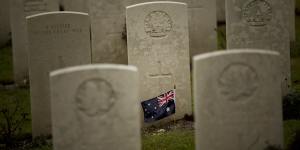 An Australian flag adorns the headstone of an unknown soldier at the World War I Australian National Memorial in Villers-Bretonneux,France.