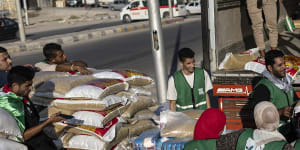 Volunteers load food and supplies onto trucks in an aid convoy for Gaza in North Sinai,Egypt.