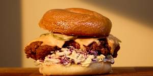 “The Tokyo” fried chicken bagel with cabbage slaw,provolone cheese and chilli-mayo at Roman’s Deli.