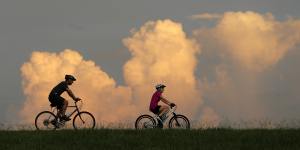 People ride bikes on the Mississippi River levee in Jefferson Parish,a suburb of New Orleans,Louisiana. The state's representative in Congress is against Joe Biden's climate plans.