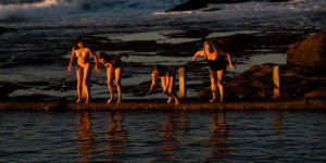 After viewing the sunrise,a group of swimmers dive into Mahon Pool at Maroubra,on the last day of winter,in Sydney. 