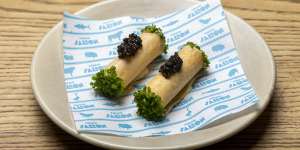 Feuille de brick,thin pastry tubes filled with whipped Brillat-Savarin cheese and topped with caviar.