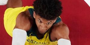 Matisse Thybulle (left) and Nic Kay (right) control a rebound.