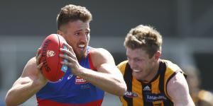 Marcus Bontempelli of the Bulldogs is tackled by Hawthorn’s Ben McEvoy.