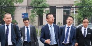 Li Haojun (third from left) lawyer for jailed Crown employee Jason O'Connor arrives at the Baoshan District Court on Monday,flanked by other members of his firm. 