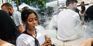 People smoke marijuana at the Thai High Convention in Chiang Mai in December.