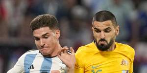 Argentina’s Julian Alvarez,left,and Australia’s Aziz Behich vie for the ball.