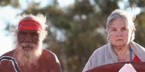 Mutitjulu elder Rolley Mintuma joins Pat Anderson as she carries the Uluru Statement from the Heart last year. 