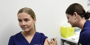 Registered nurse Rebecca DeJong receives a dose of the Pfizer COVID-19 vaccination at the Townsville University Hospital hub in March.