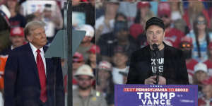 Donald Trump listens to Elon Musk at a campaign rally in Butler,Pennsylvania.