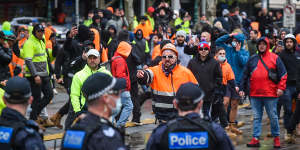 Police and protesters face off out the front of the CFMEU office on Elizabeth Street on Monday. 