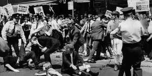 Police move people protesting the visit of American President Lyndon B. Johnson in Liverpool Street