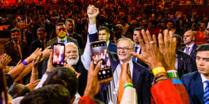 Indian Prime Minister Narendra Modi and his Australian counterpart Anthony Albanese exit the arena on Tuesday night. 