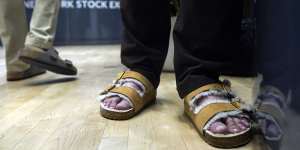Traders on the floor of the New York Stock Exchange wear Birkenstock sandals during company’s IPO.