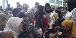 Relatives of passengers comfort each other at Depati Amir Airport in Pangkal Pinang as they wait for news on a Lion Air plane that crashed off Java Island.