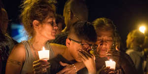 Mona Rodriguez holds her 12-year-old son,J Anthony Hernandez,during a candlelight vigil held for the victims of a fatal shooting at the First Baptist Church of Sutherland Springs.