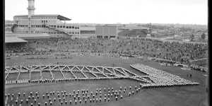 Thousands of children formed the shape of the Harbour Bridge to mark the opening of the bridge. The image was a panorama requiring more than one negative. This is half.