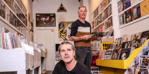 Leigh Carmichael (left) with Music Without Frontiers manager Mel Stewart in the Hobart record store. Carmichael made a vow to do everything he could to help save it.