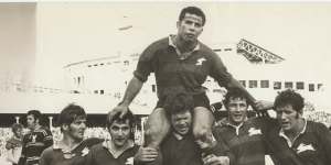John Sattler,suffering a broken jaw,is chaired off by Bob McCarthy and Souths teammates after the Rabbitohs beat Manly in the 1970 grand final.