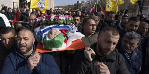 Mourners carry the body of Palestinian-American Omar Assad,during his funeral in the West Bank village of Jiljiliya,north of Ramallah. 
