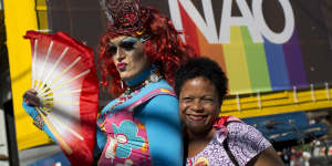 A woman and a drag queen pose for a photo backdropped by a billboard with a message that reads in Portuguese:"Not Him",in reference to presidential candidate Jair Bolsonaro. Bolsonaro has a long history of offensive comments about gays,women and minorities. 