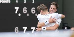 Harri Heliovaara of Finland,left,hugs playing partner Henry Patten of Britain on winning the championship point.