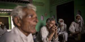 People discuss how to handle the pandemic in the village of Basi,Uttar Pradesh,India.