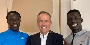Bol with flatmate and fellow runner Joseph Deng and Bill Shorten,who helped the pair find a rental flat.