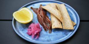 Ortiz anchovies with house-pickled onions,a lemon cheek and crostini.