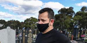 Spiros Dimitriou at his father John’s grave,at the Northern Memorial Park in Glenroy. John died after acquiring a coronavirus infection at St Basil's after living there for almost three years.